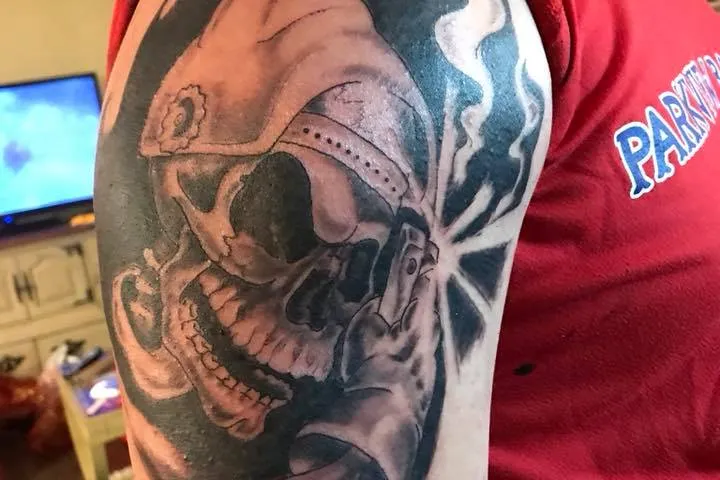 black white skull tattoo on right arm